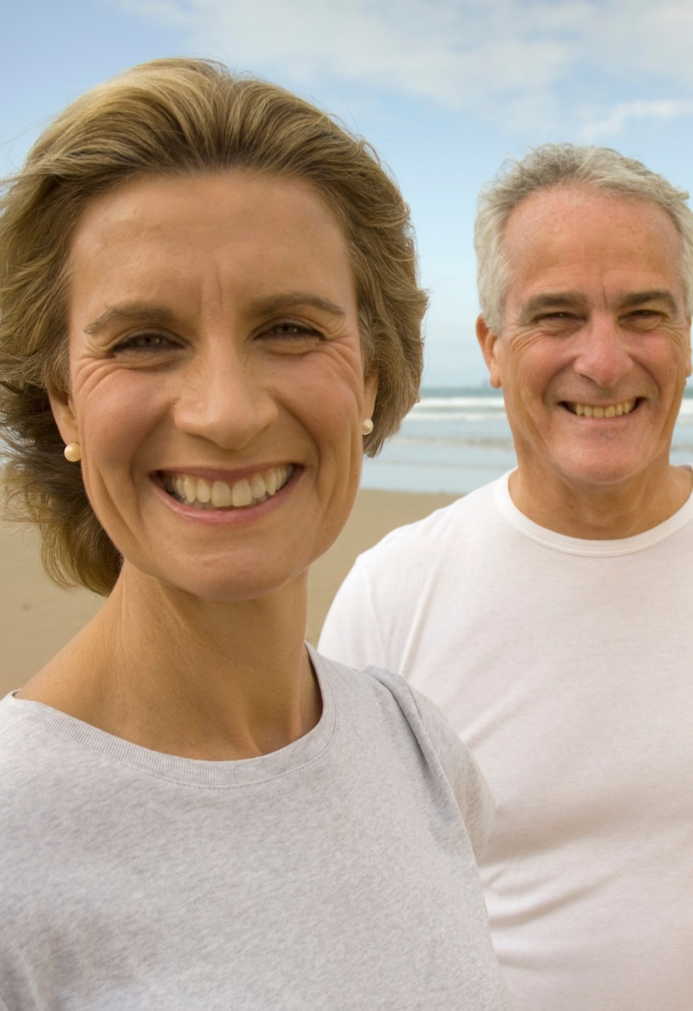 portrait of couple smiling on a beach